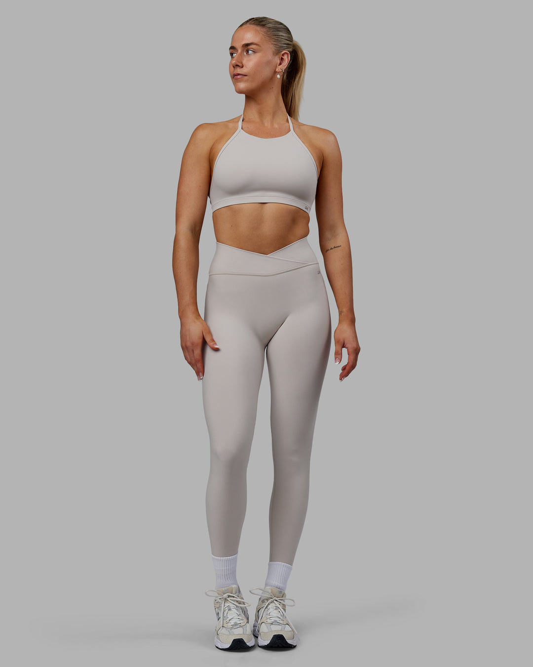 Woman wearing Sara Strike Ultra High-Rise Cross Over Waist Full Length Legging - Shale Beige