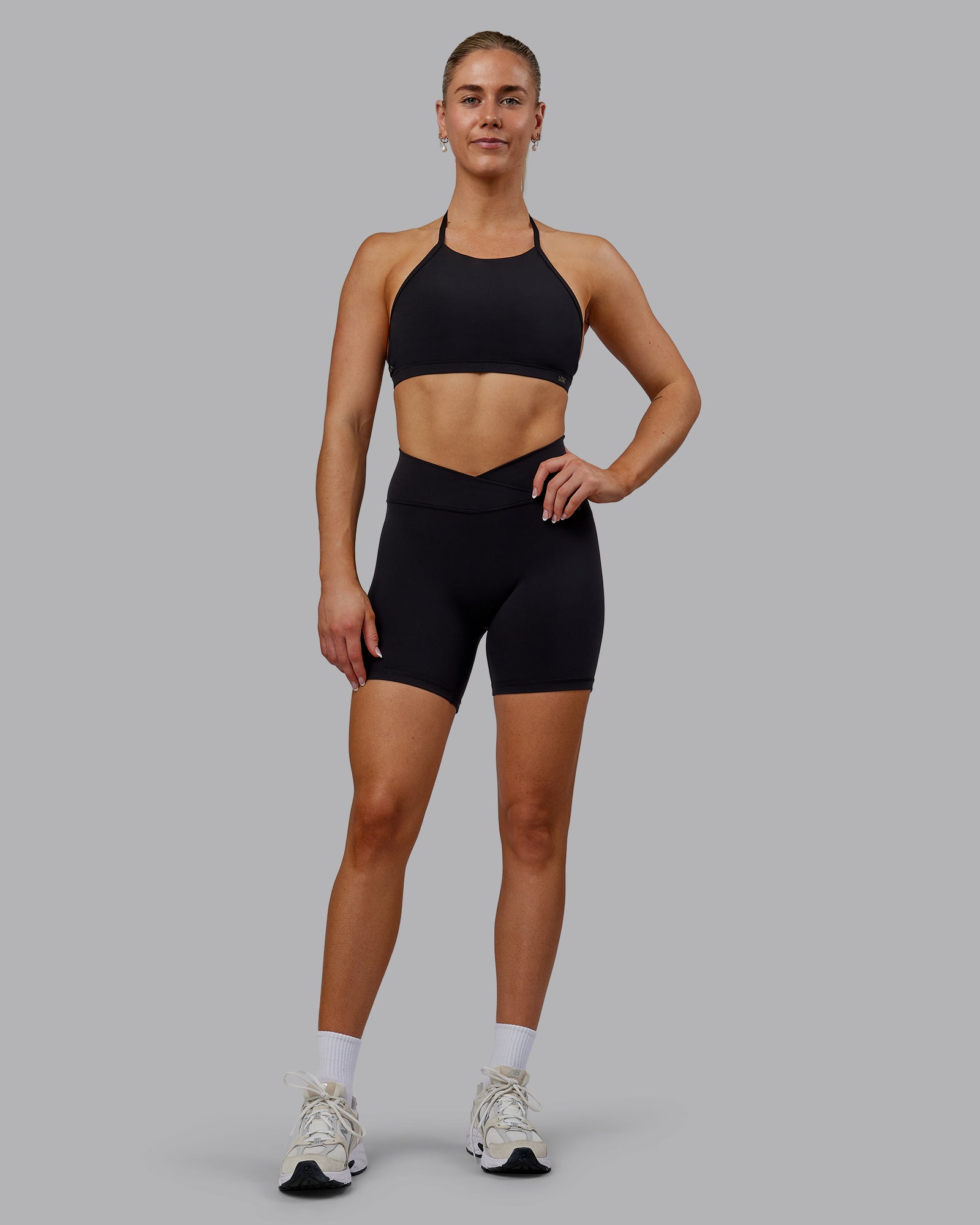 Woman wearing Sara Strike Ultra High-Rise Cross Over Waist 6" Short - Black