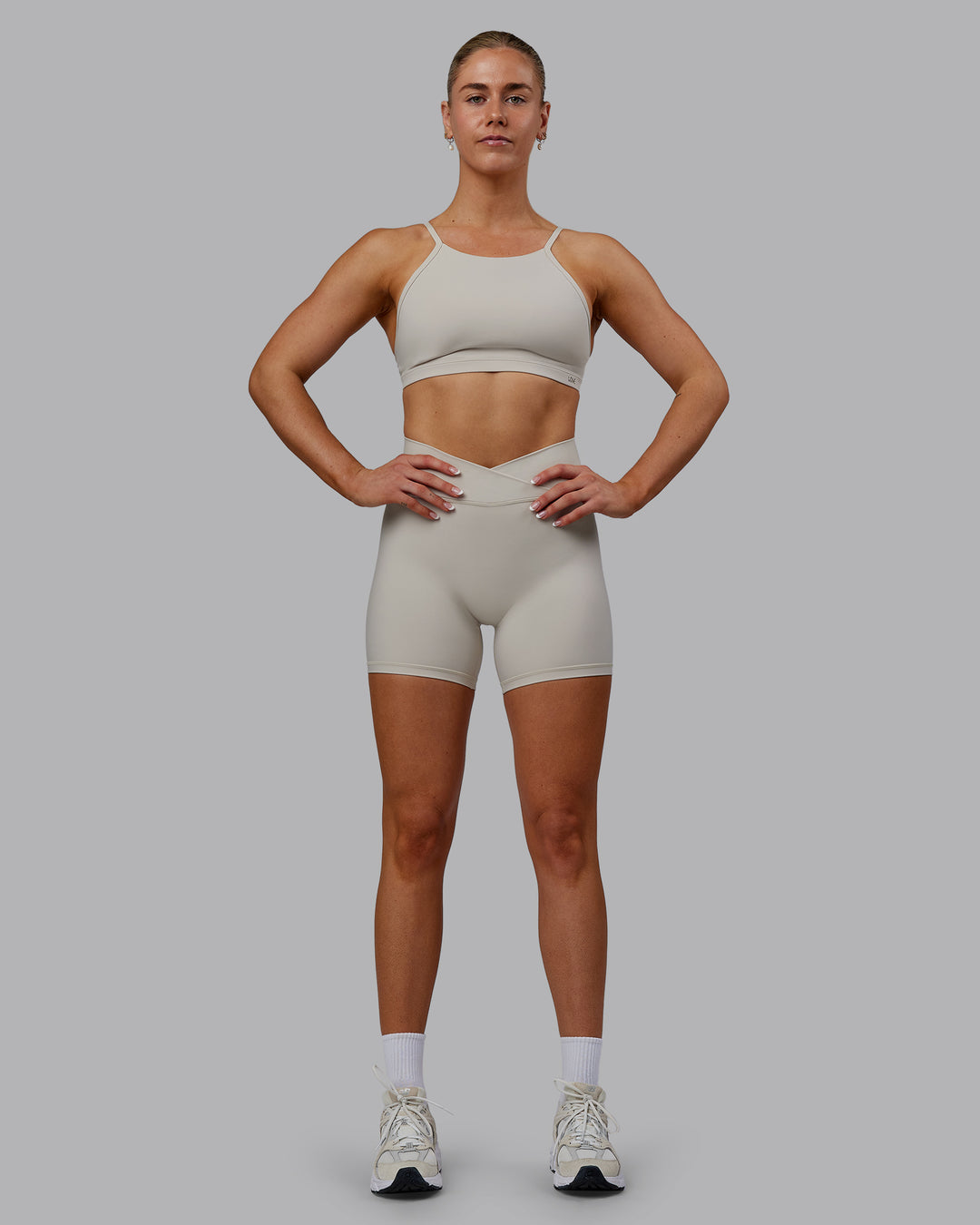 Woman wearing Sara Strike Ultra High-Rise Cross Over Waist 6&quot; Short - Shale Beige