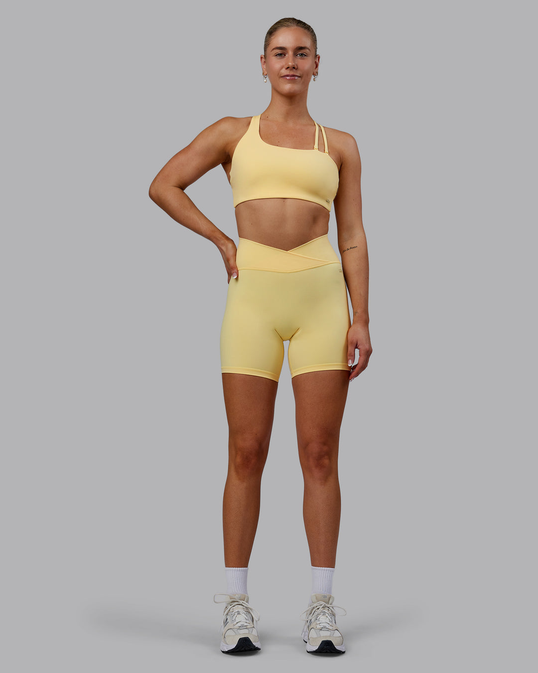 Woman wearing Sara Strike Ultra High-Rise Cross Over Waist 6&quot; Short - Sunflower