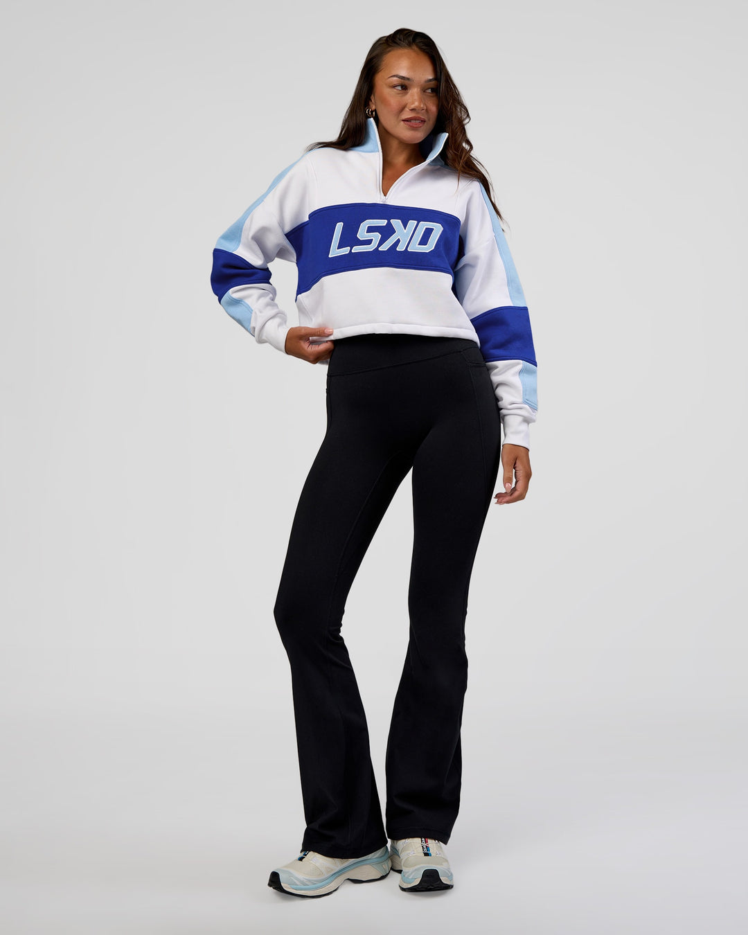 Woman wearing Slam Quarter Zip Sweater - White-Electric Indigo | Model:Kirstyn | Size:S