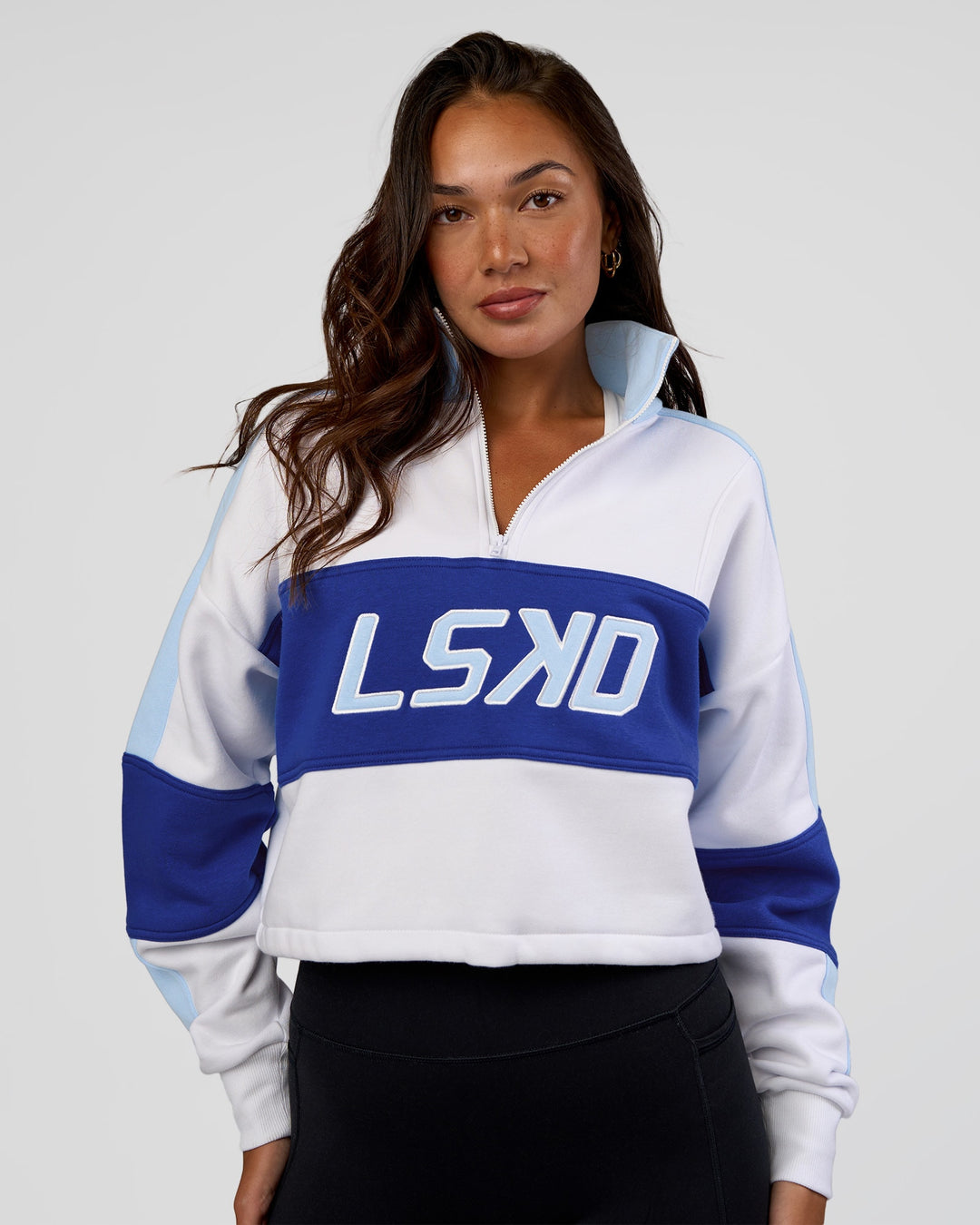 Woman wearing Slam Quarter Zip Sweater - White-Electric Indigo | Model:Kirstyn | Size:S