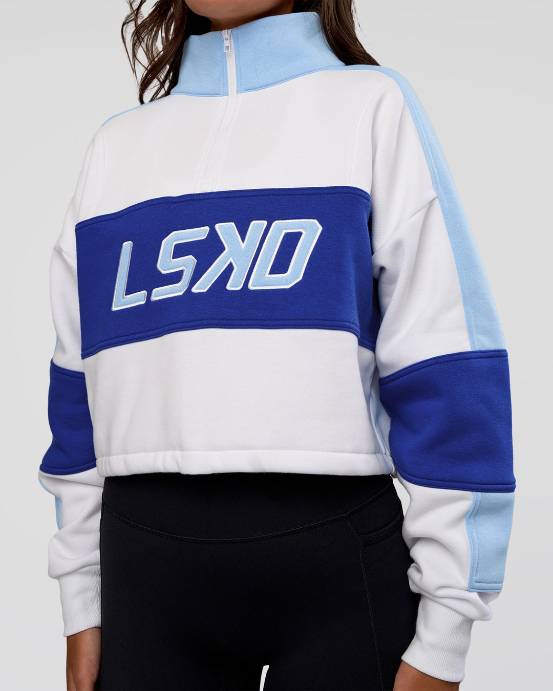 Woman wearing Slam Quarter Zip Sweater - White-Electric Indigo | Model:Kirstyn | Size:S