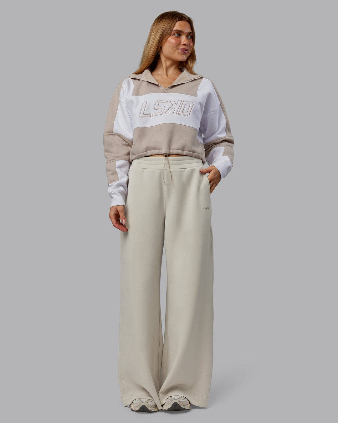 Woman wearing Slam Quarter Zip Sweater - Shale Beige-White | Model:Emilie | Size:S