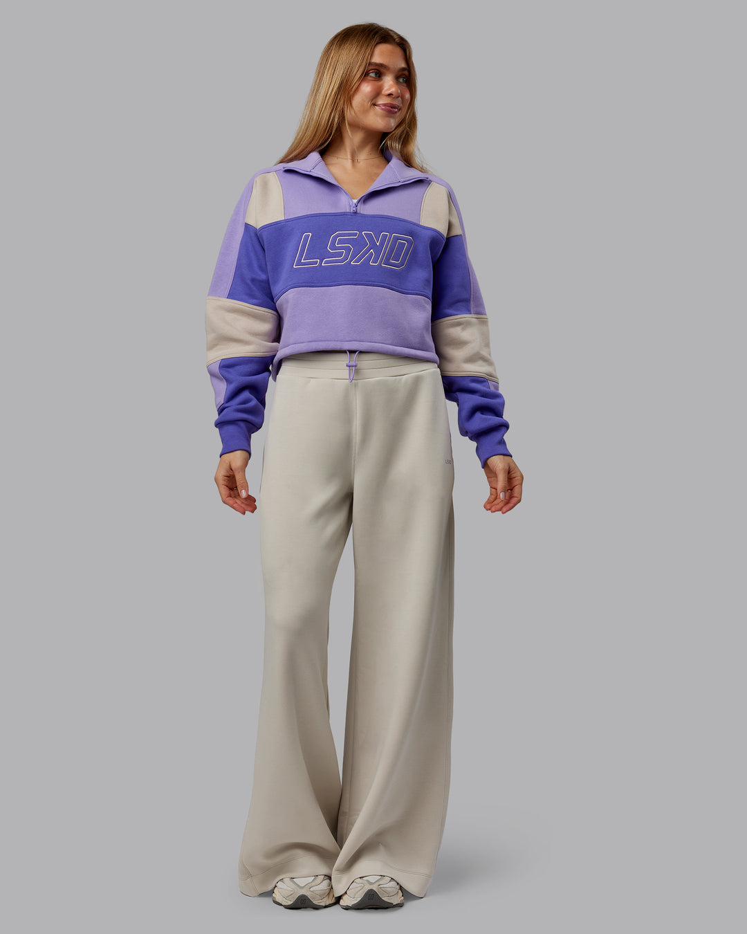 Woman wearing Slam Quarter Zip Sweater - Violet Ray-Royal Purple | Model:Emilie | Size:S