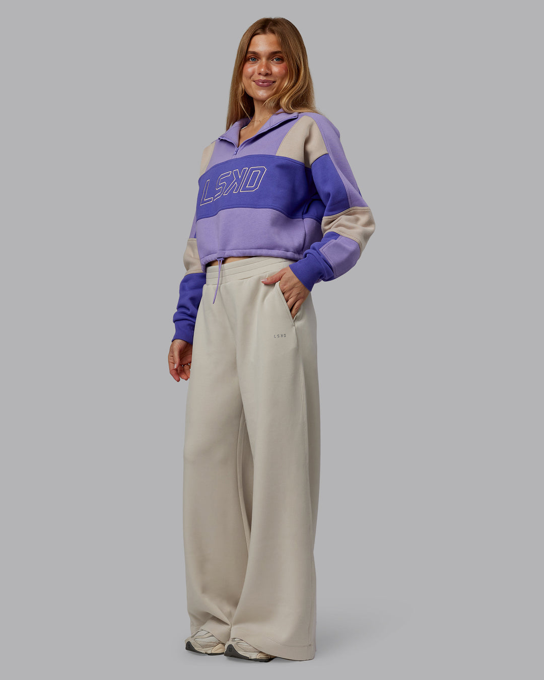 Woman wearing Slam Quarter Zip Sweater - Violet Ray-Royal Purple | Model:Emilie | Size:S