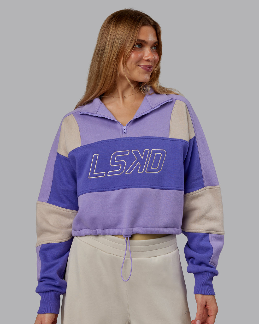 Woman wearing Slam Quarter Zip Sweater - Violet Ray-Royal Purple | Model:Emilie | Size:S