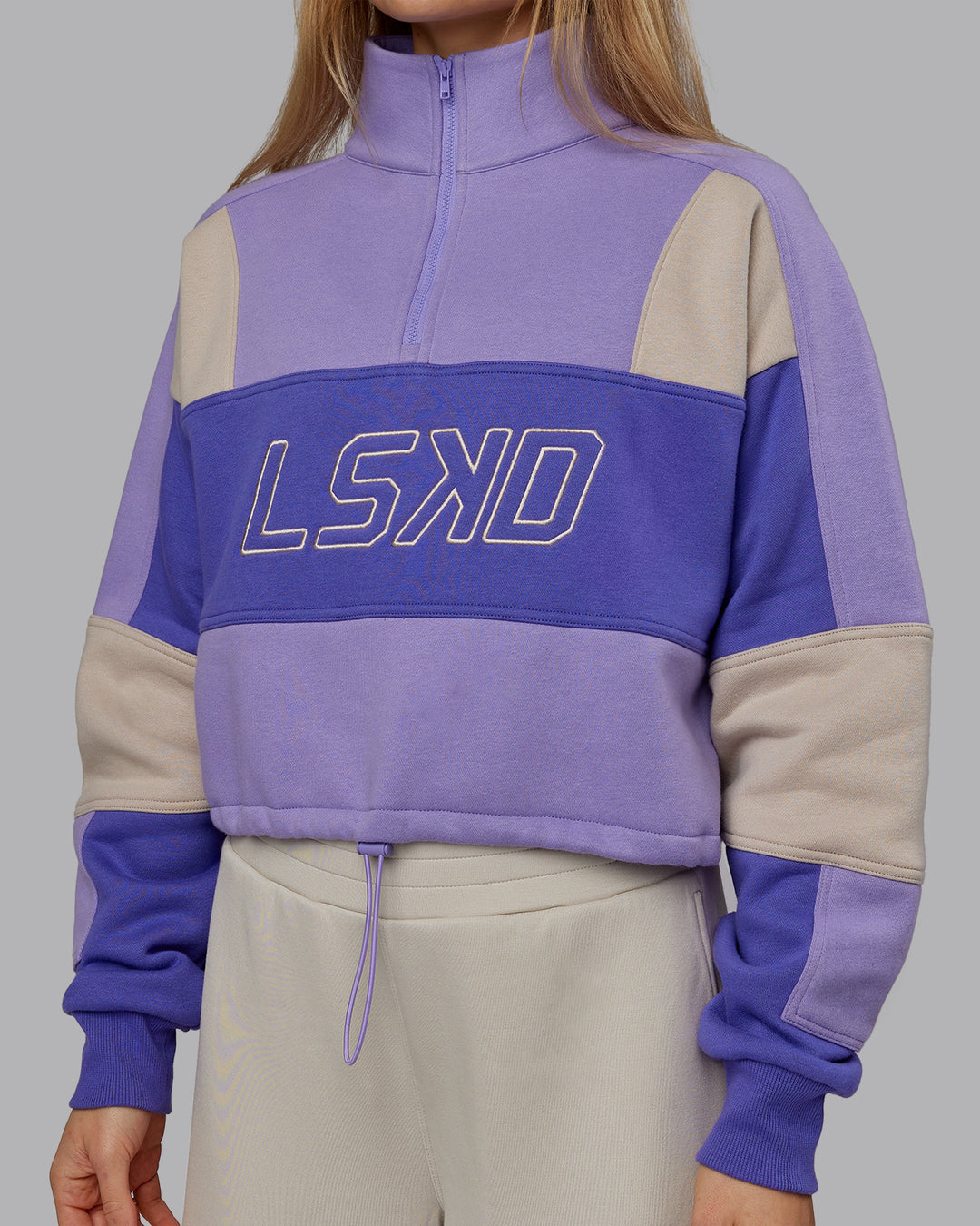 Woman wearing Slam Quarter Zip Sweater - Violet Ray-Royal Purple | Model:Emilie | Size:S