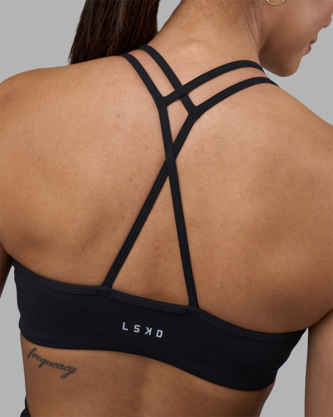 Woman wearing Stamina Pulse Sports Bra - Black | Model:Rhiley | Size:S