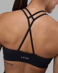 Woman wearing Stamina Pulse Sports Bra - Black | Model:Rhiley | Size:S