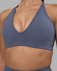 Woman wearing Stamina Pulse Sports Bra - Night Shadow | Model:Rhiley | Size:S