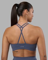 Woman wearing Stamina Pulse Sports Bra - Night Shadow | Model:Rhiley | Size:S