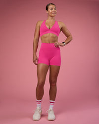 Woman wearing Fusion Ultra High-Rise 4" Short Pockets - Ultra Pink | Model:Hannah | Size:S