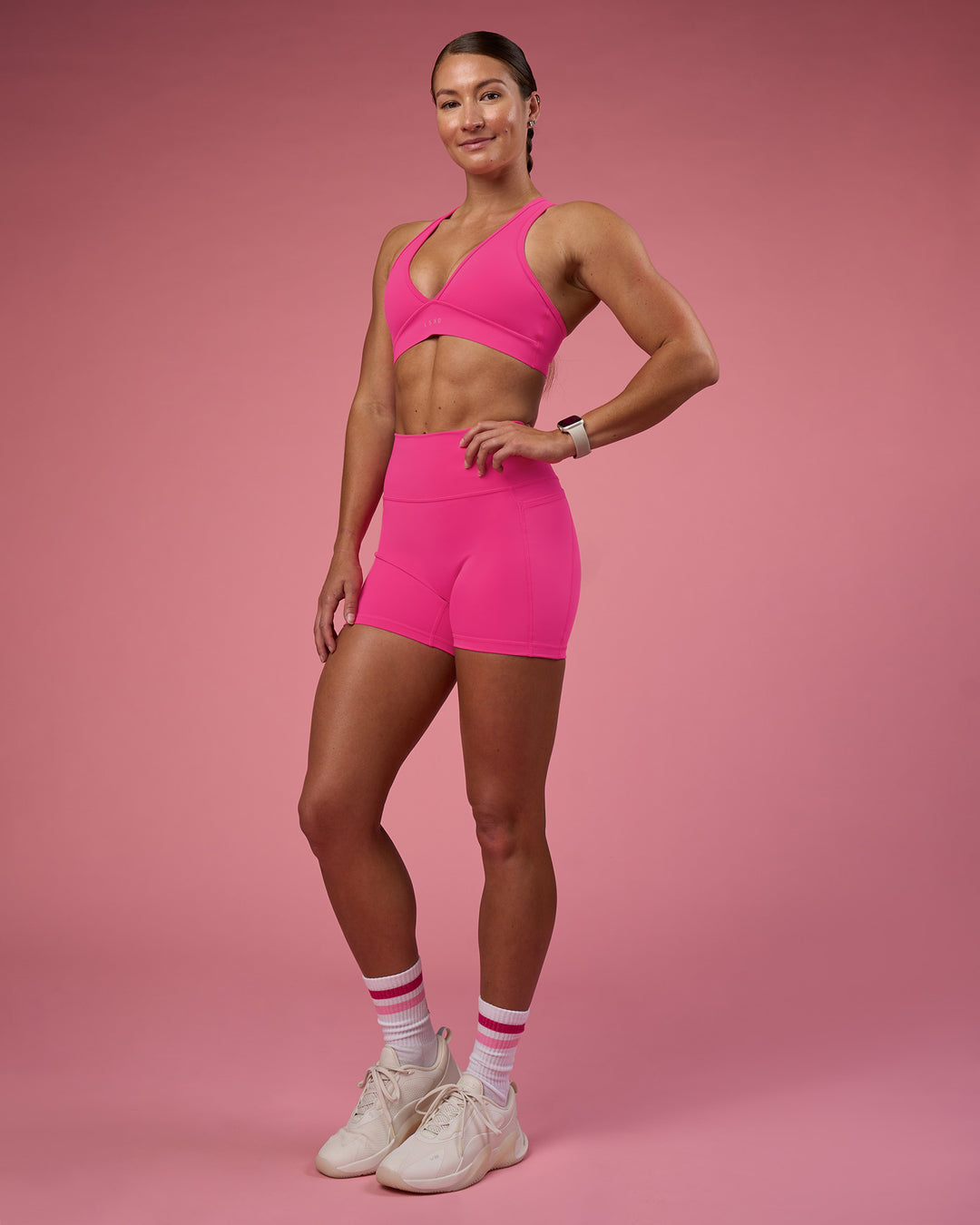 Woman wearing Fusion Ultra High-Rise 4&quot; Short Pockets - Ultra Pink | Model:Hannah | Size:S