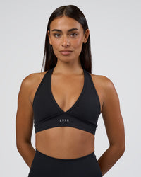 Woman wearing Stamina Sports Bra - Black | Set:true | Angle:front | Model:Ruby | Size:S
