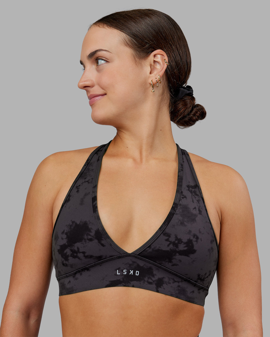 Woman wearing Stamina Sports Bra - Black Tie Dye | Set:true | Angle:front | Model:Keisha | Size:S - view 1