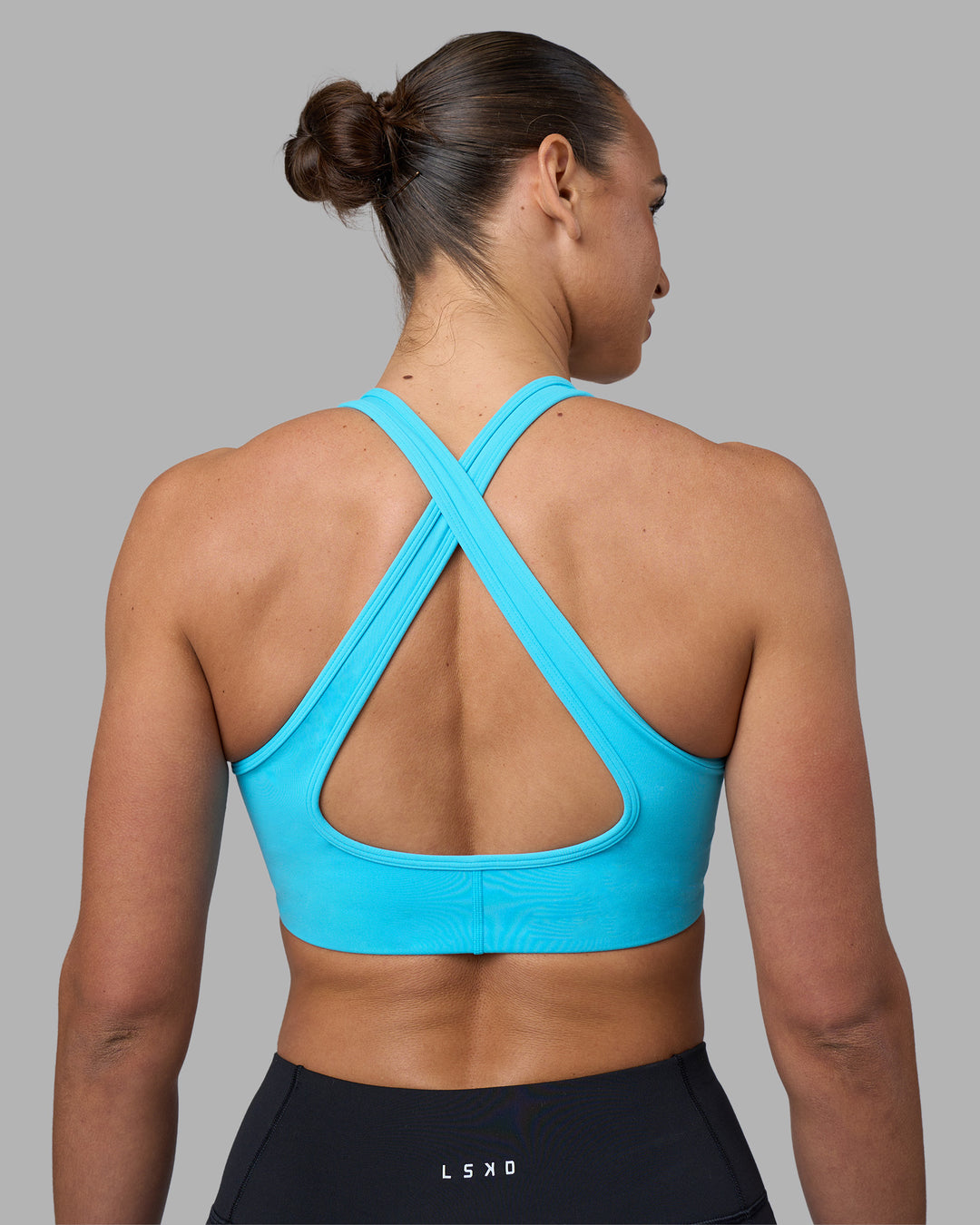Woman wearing Stamina Sports Bra - Blue Atoll | Model:Sophie | Size:S