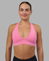 Woman wearing Stamina Sports Bra - Candy Pink | Set:true | Angle:front | Model:Keisha | Size:S