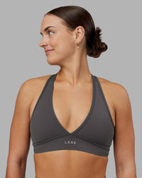 Woman wearing Stamina Sports Bra - Dark Storm | Set:true | Angle:front | Model:Keisha | Size:S