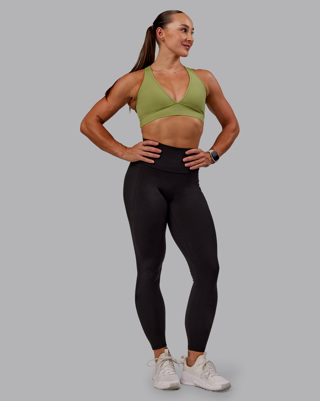 Woman wearing Stamina Sports Bra in Moss Stone | Size:S