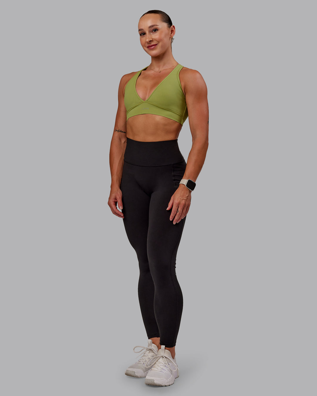 Woman wearing Stamina Sports Bra in Moss Stone | Size:S