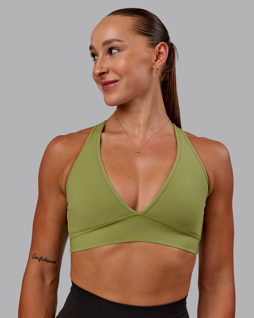 Woman wearing Stamina Sports Bra in Moss Stone | Size:S