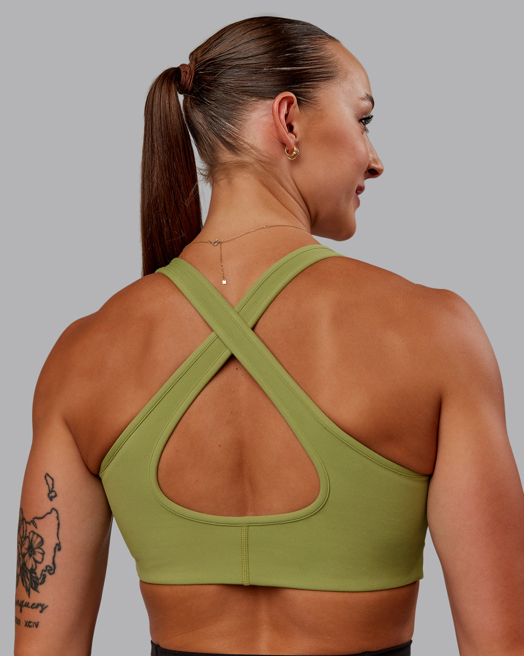 Woman wearing Stamina Sports Bra in Moss Stone | Size:S