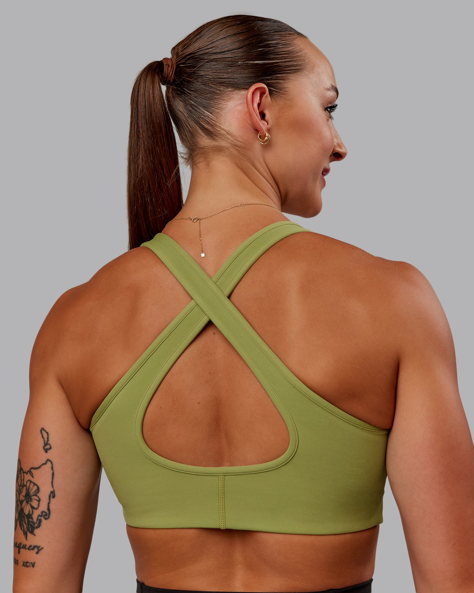 Woman wearing Stamina Sports Bra in Moss Stone | Size:S