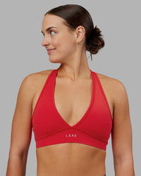 Woman wearing Stamina Sports Bra - Scarlet | Set:true | Angle:front | Model:Keisha | Size:S