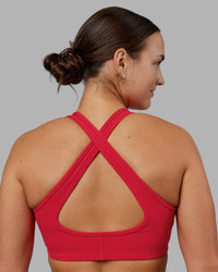 Woman wearing Stamina Sports Bra - Scarlet | Set:true | Angle:back | Model:Keisha | Size:S