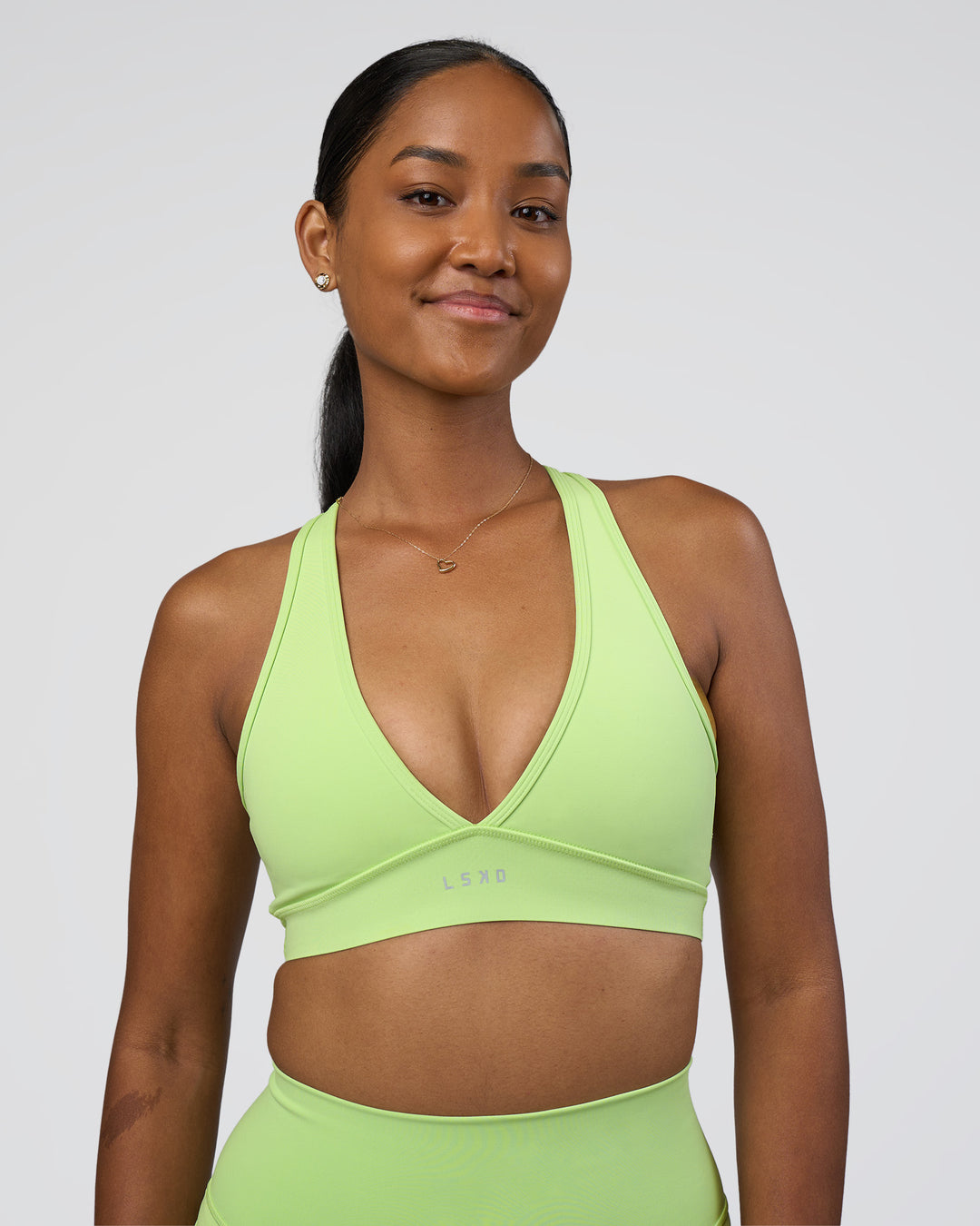 Woman wearing Stamina Sports Bra - Solar Lime | Model:Rica | Size:S