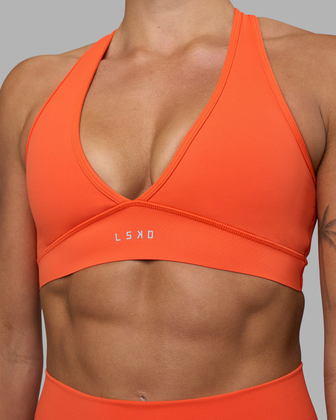 Woman wearing Stamina Sports Bra - Ultra Orange | Model:Katie | Size:S