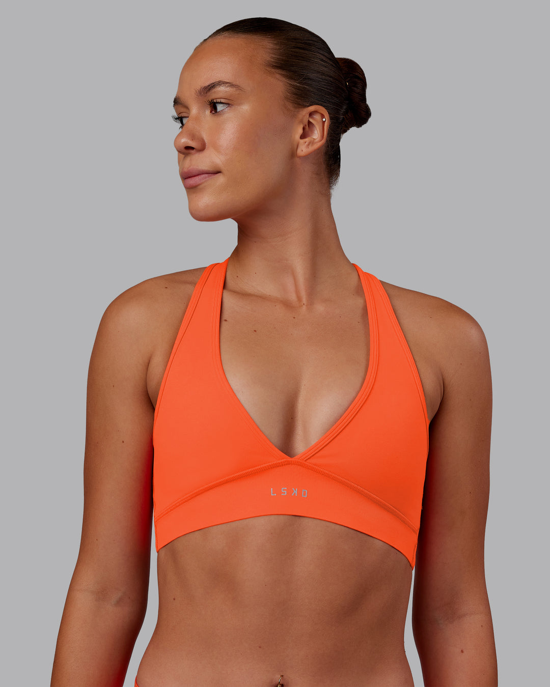 Woman wearing Stamina Sports Bra - Ultra Orange | Model:Charlize | Size:S