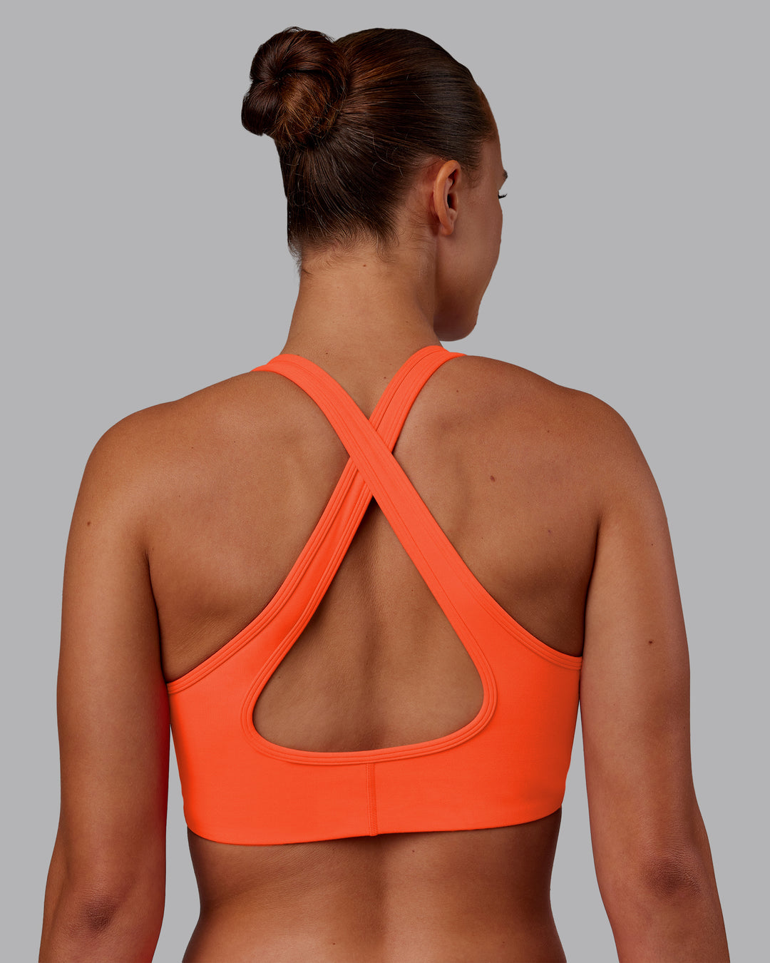 Woman wearing Stamina Sports Bra - Ultra Orange | Model:Charlize | Size:S