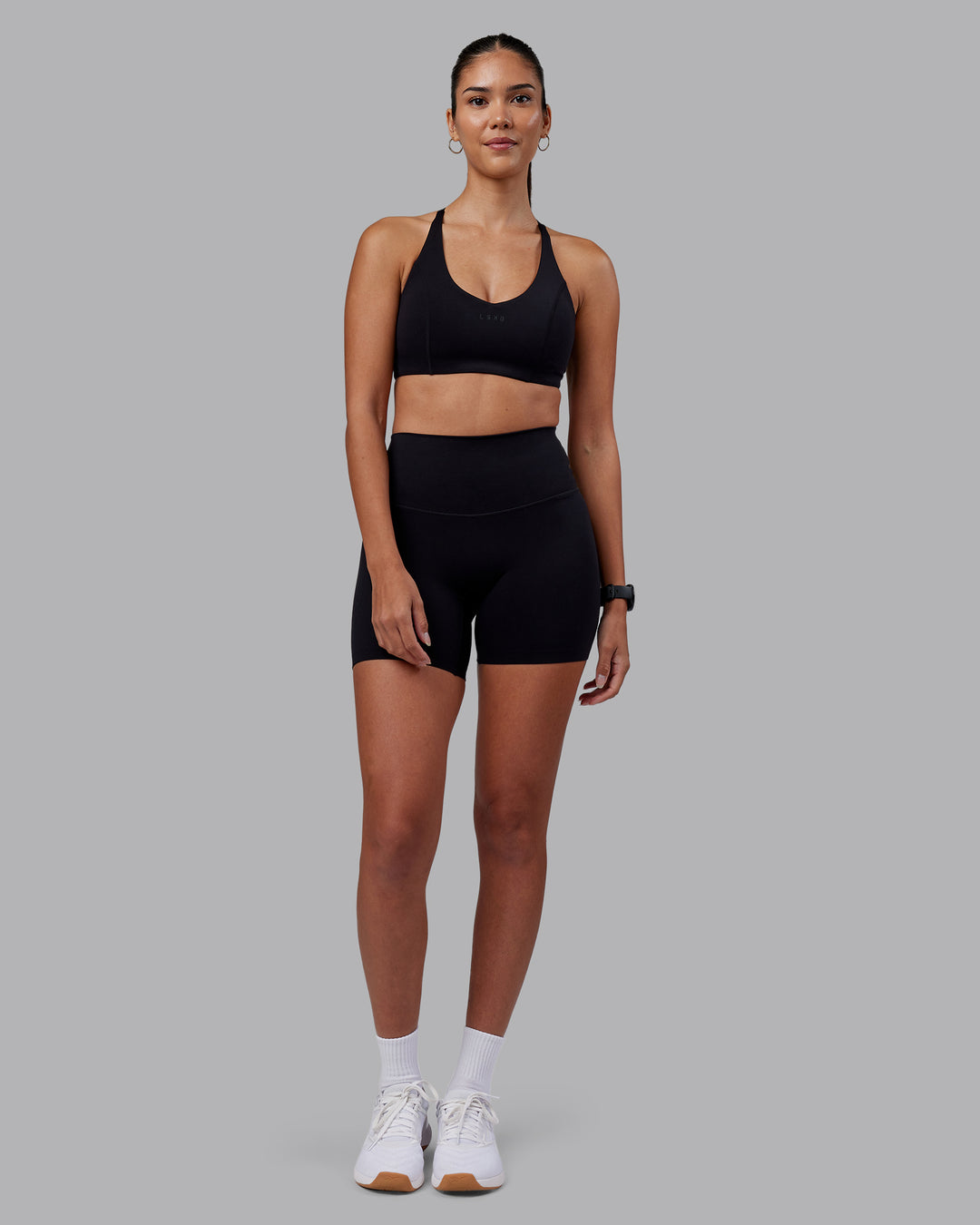 Woman wearing Stellar Sports Bra - Black | Model:Rhiley | Size:S