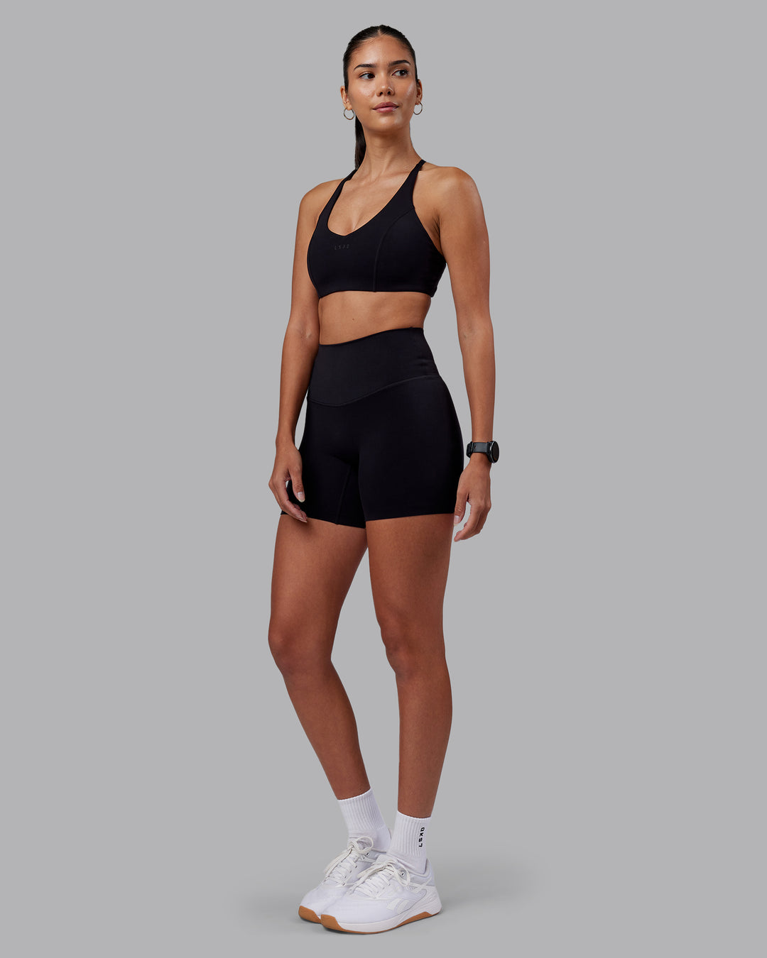 Woman wearing Stellar Sports Bra - Black | Model:Rhiley | Size:S