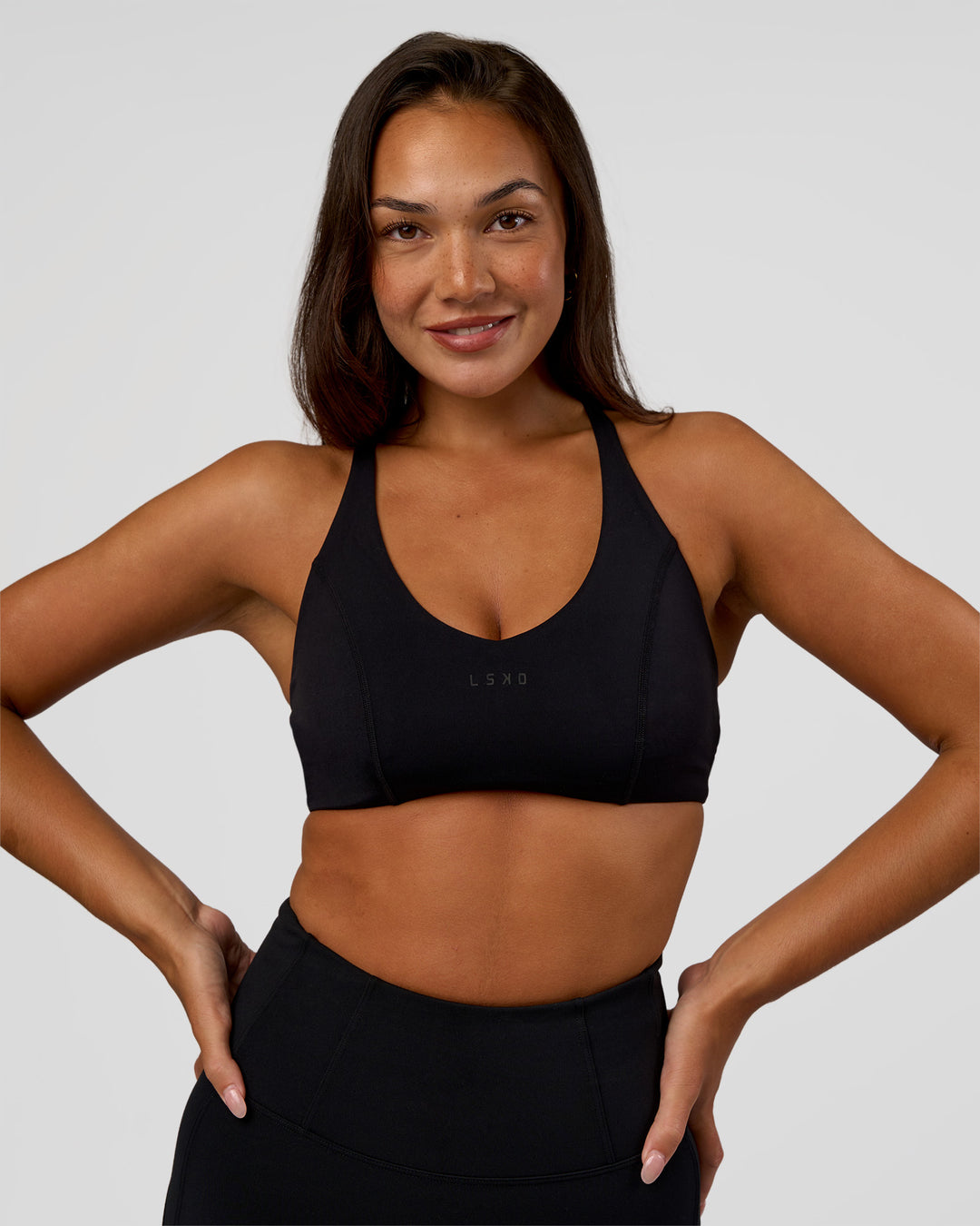 Woman wearing Stellar Sports Bra - Black | Model:Kirstyn | Size:S