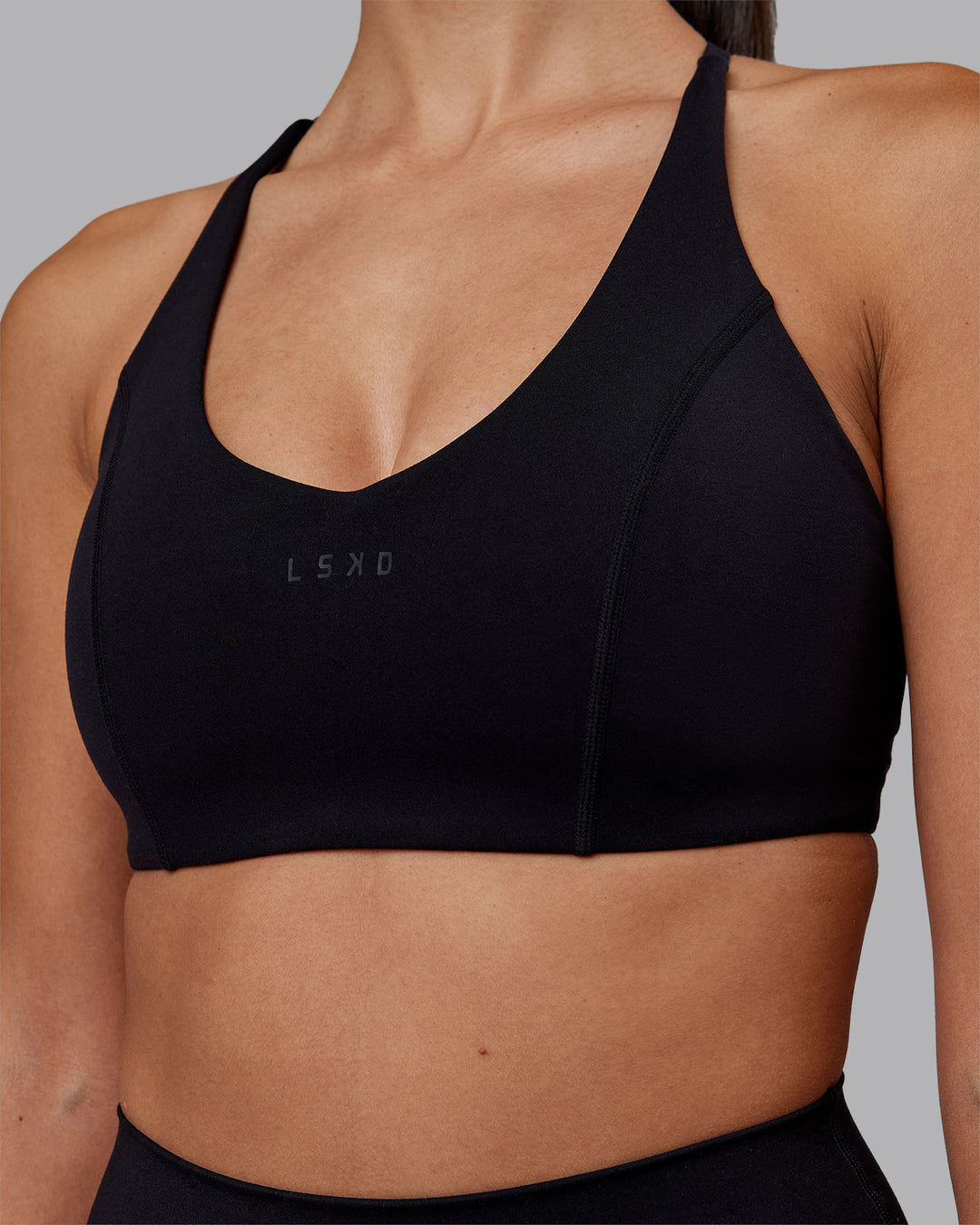 Woman wearing Stellar Sports Bra - Black | Model:Rhiley | Size:S
