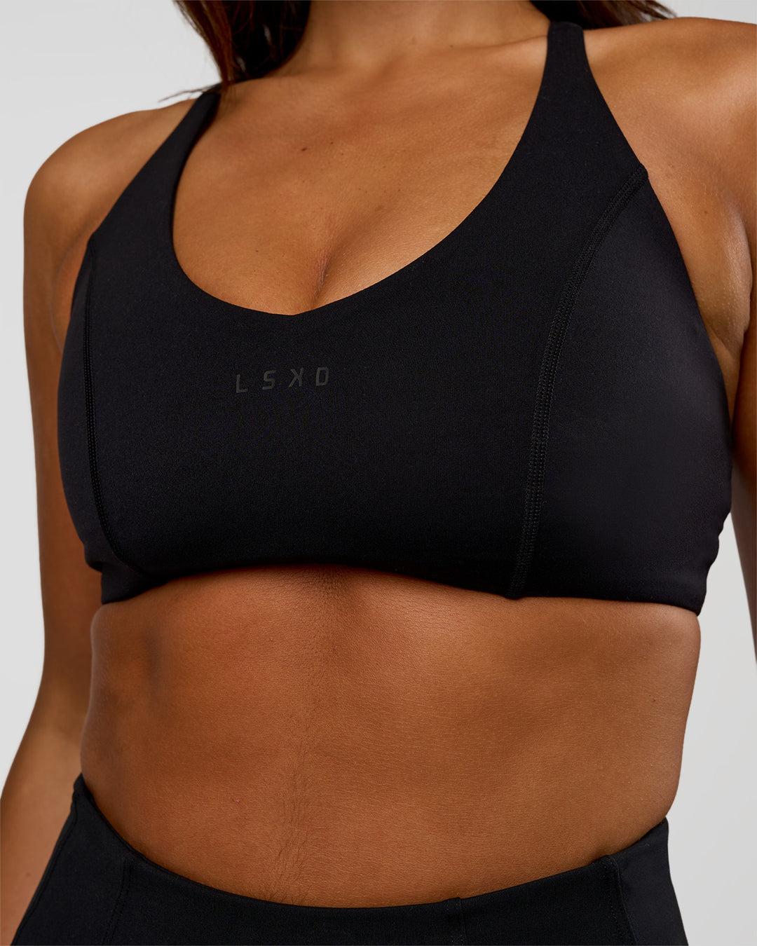 Woman wearing Stellar Sports Bra - Black | Model:Kirstyn | Size:S