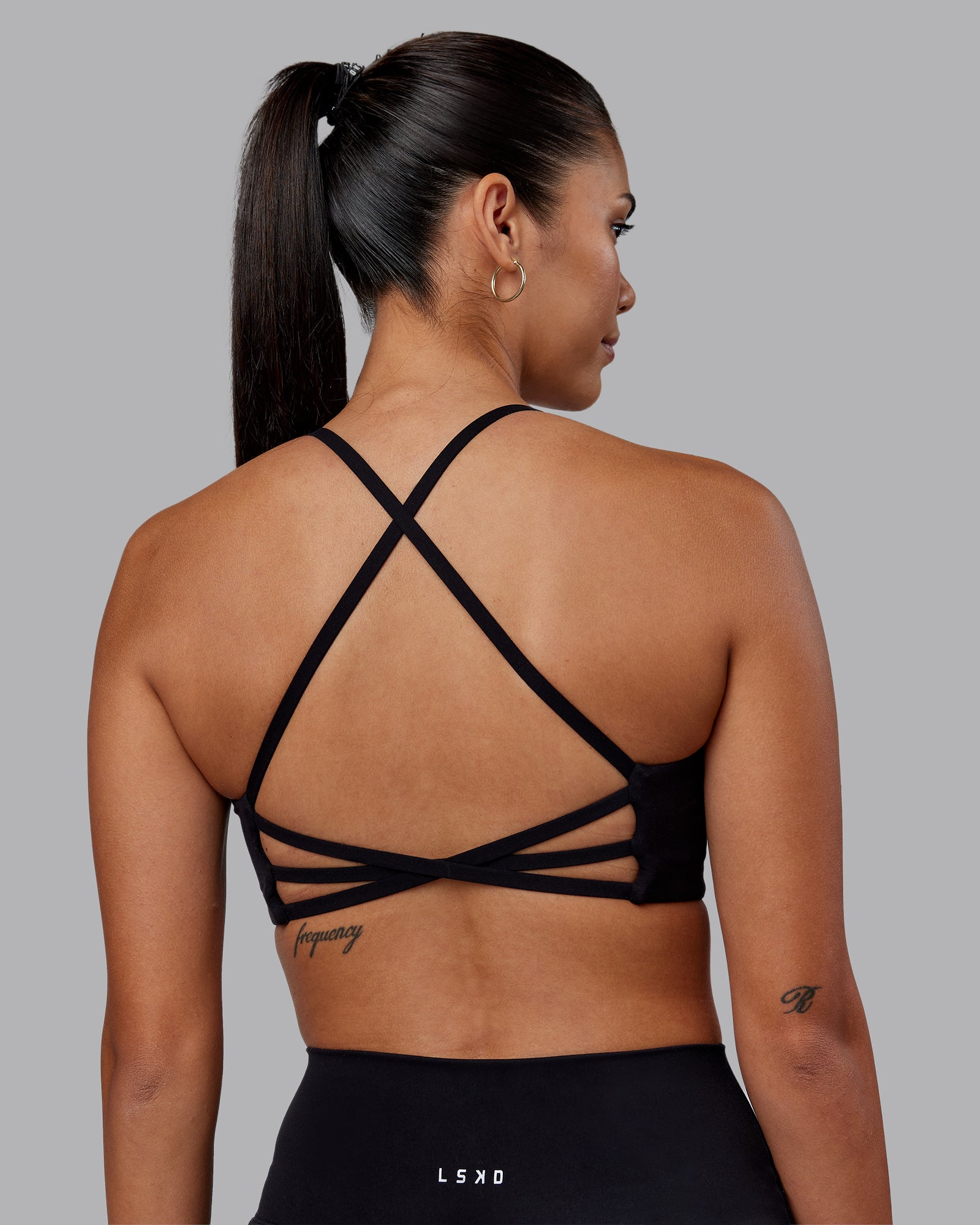 Woman wearing Stellar Sports Bra - Black | Model:Rhiley | Size:S