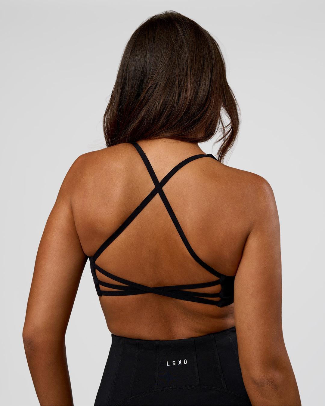 Woman wearing Stellar Sports Bra - Black | Model:Kirstyn | Size:S