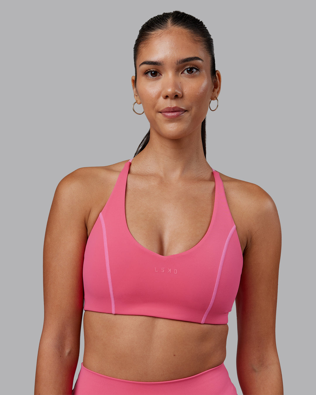 Woman wearing Stellar Sports Bra - Hot Pink | Model:Rhiley | Size:S