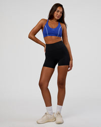 Woman wearing Stellar Sports Bra - Power Cobalt | Model:Kirstyn | Size:S