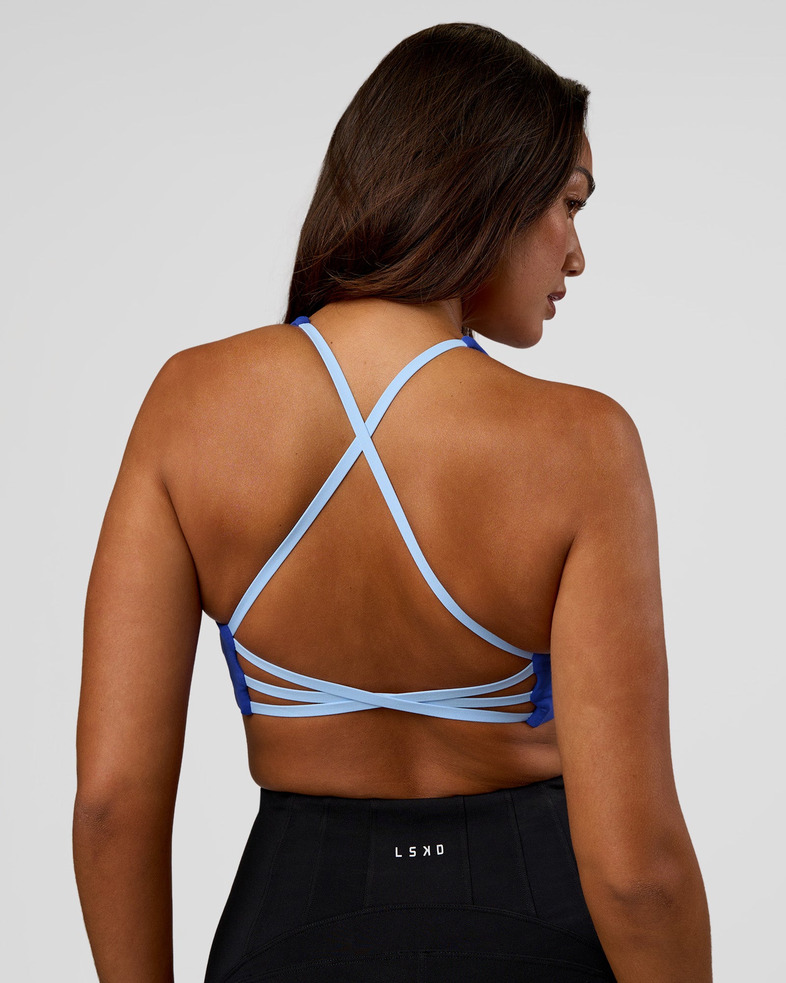 Woman wearing Stellar Sports Bra - Power Cobalt | Model:Kirstyn | Size:S