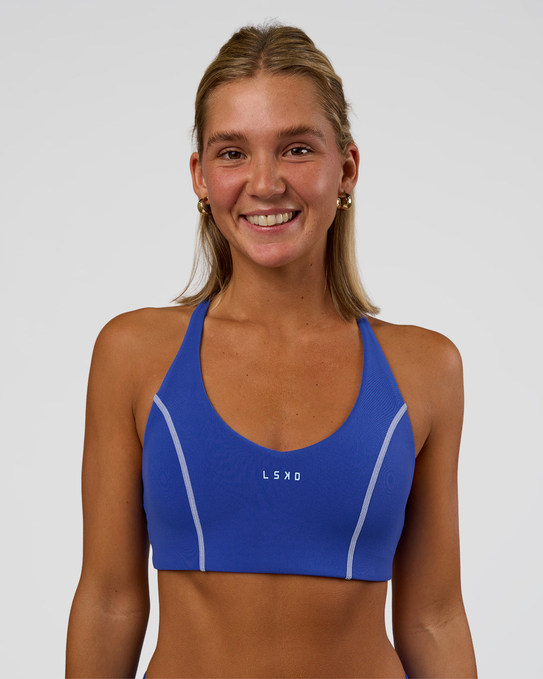Woman wearing Stellar Sports Bra - Power Cobalt | Model:Amity | Size:S