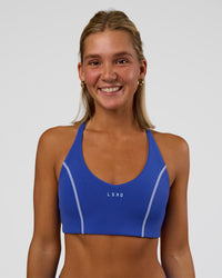 Woman wearing Stellar Sports Bra - Power Cobalt | Model:Amity | Size:S