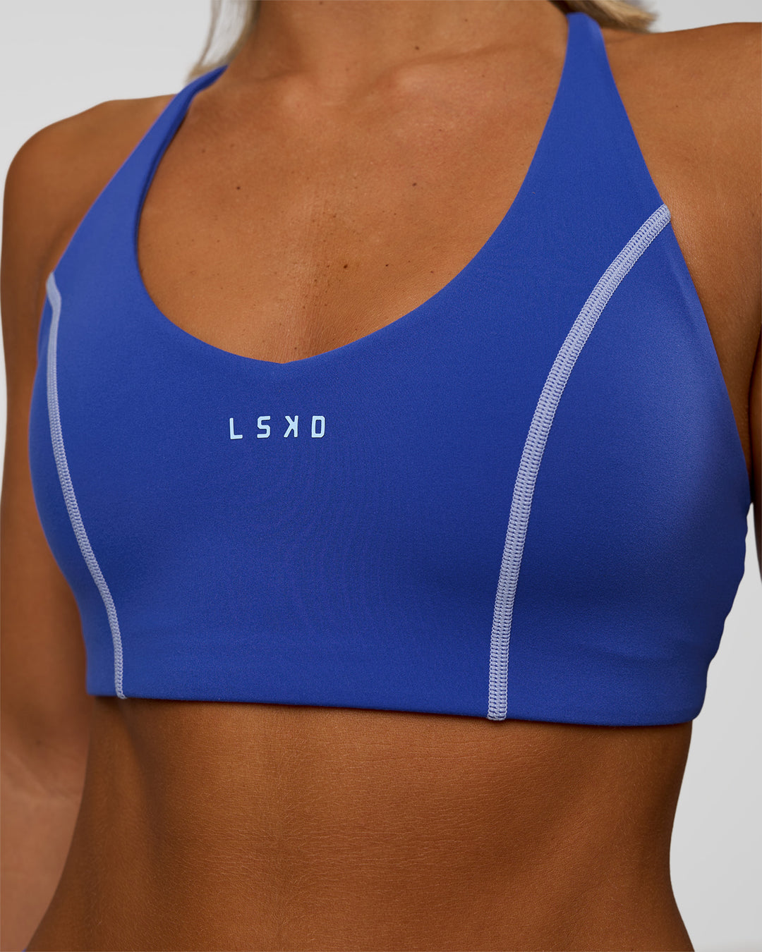 Woman wearing Stellar Sports Bra - Power Cobalt | Model:Amity | Size:S