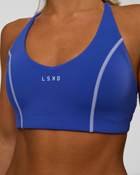 Woman wearing Stellar Sports Bra - Power Cobalt | Model:Amity | Size:S