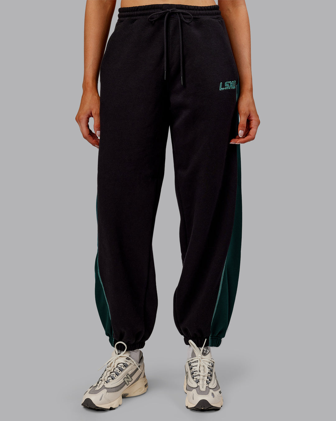 Woman wearing Stitch Up Fleece Sweat Pant - Black/Dark Moss | Model:Ella | Size:S