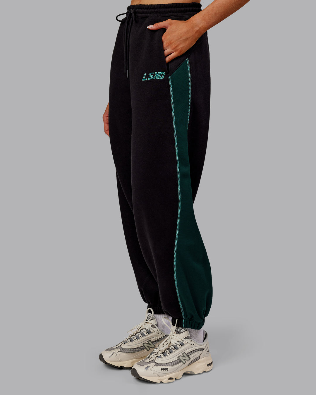 Woman wearing Stitch Up Fleece Sweat Pant - Black/Dark Moss | Model:Ella | Size:S